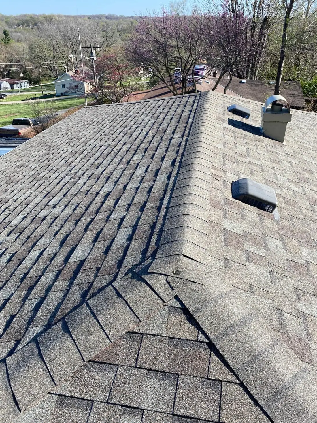 New shingle roof with ridge cap and low flat vents
