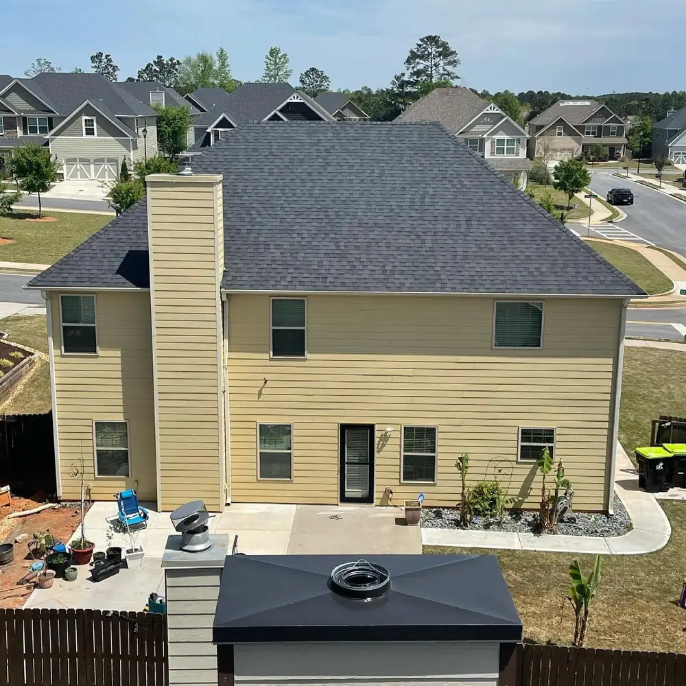 Two-story house with a new charcoal shingle roof, seen from a rooftop